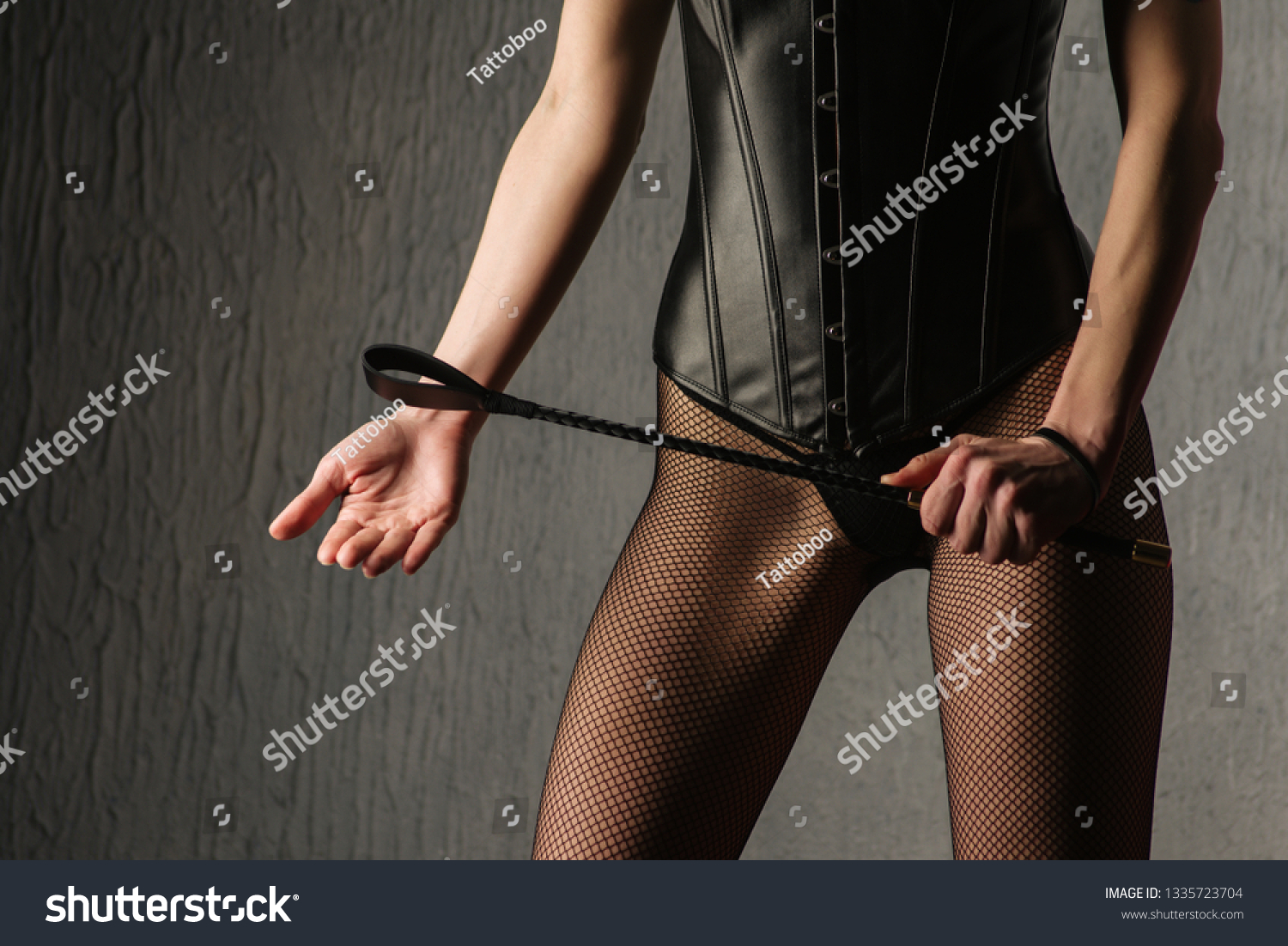 domanant women in leather and boots whipping men